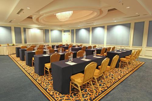 a conference room with tables and chairs in it at Harmoni One Convention Hotel and Service Apartments in Batam Center