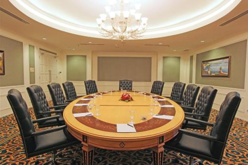 a conference room with a large wooden table and chairs at Harmoni One Convention Hotel and Service Apartments in Batam Center