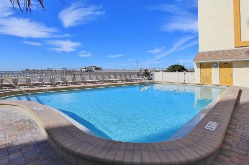 a large pool with blue water in front of a building at Anglers Cove 602 in St. Pete Beach