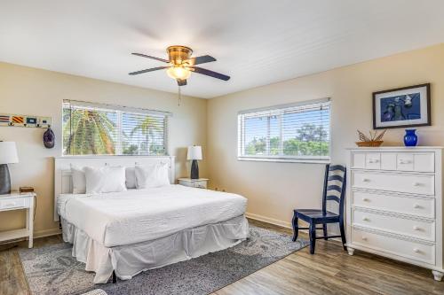 a bedroom with a white bed and a ceiling fan at Sea and Sky in Marathon