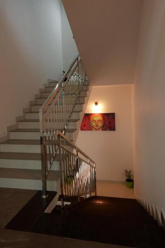 a staircase in a house with a painting on the wall at Isha Residency in Alwaye