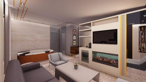 uma sala de estar com uma televisão e um sofá e um sofá em THE HUBİ HOTEL em Istambul