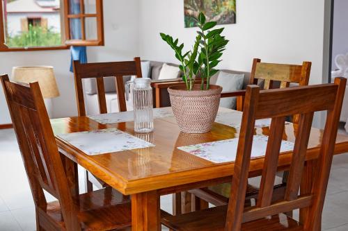 a wooden table with chairs and a plant on it at Le Be-Mahot - Hell Bourg in Salazie