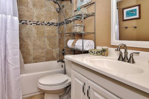 a bathroom with a sink and a toilet and a tub at Belleair Beach Club 315 in Clearwater Beach