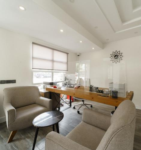 a office with a desk and two chairs and a table at Hotel Centro Bodrum in Bodrum City