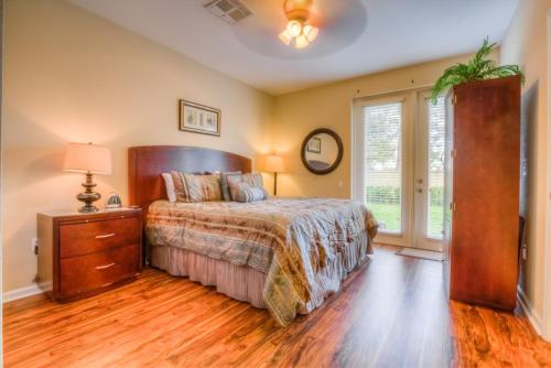 a bedroom with a bed and a dresser and a window at Gorgeous Townhome w FREE Resort Access in Orlando