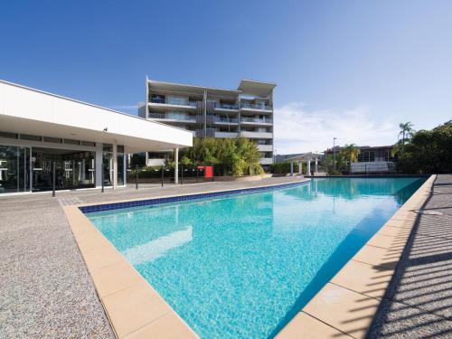 a large swimming pool in front of a building at Oaks Brisbane Mews Suites in Brisbane
