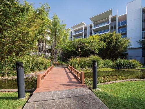 a walkway leading to a park with a fire hydrant at Oaks Brisbane Mews Suites in Brisbane