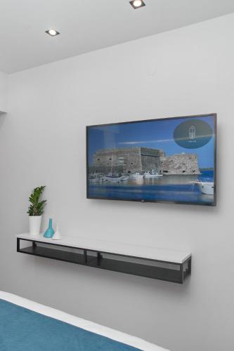 a flat screen tv hanging on a wall at 7Rizes Luxury Living in Heraklio Town