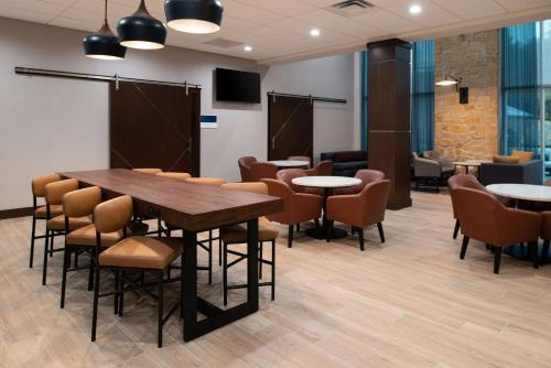 a conference room with tables and chairs and a podium at Hyatt Place Dallas/Rockwall in Rockwall