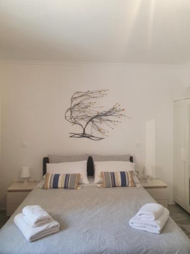 a bedroom with a bed with two towels on it at Kalamia's cozy apartment in Pyrgos