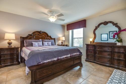 a bedroom with a large bed and a mirror at Townhome wPrivate Pool & FREE on-site Water Park in Kissimmee