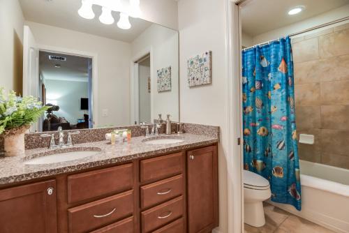 a bathroom with two sinks and a shower at Townhome wPrivate Pool & FREE on-site Water Park in Kissimmee