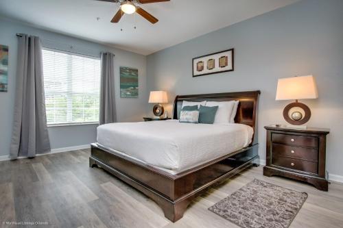 a bedroom with a bed and a ceiling fan at Beautiful Condo w Private Balcony Near Universal in Orlando