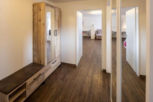 a living room with a dresser and a mirror at Hotel Peterhof - urban lifestyle Kempten in Kempten