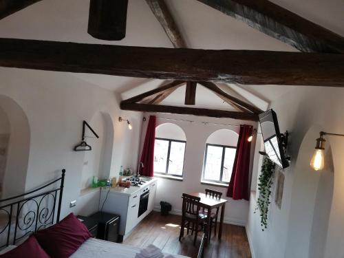 a bedroom with a bed and a table in a room at Camera Torre Panoramic in Montalto di Castro