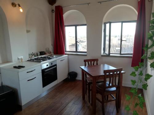 a kitchen with a table and a stove top oven at Camera Torre Panoramic in Montalto di Castro