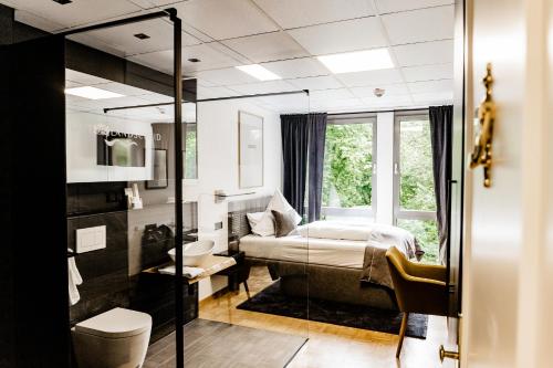 a bedroom with a bed and a window at Hotel Gut Landscheid in Burscheid