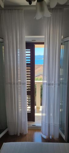 a room with white curtains and a large window at Villa Mila in Bol