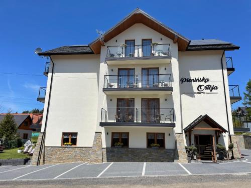 a large white building with a balcony at Pienińska Ostoja in Czorsztyn