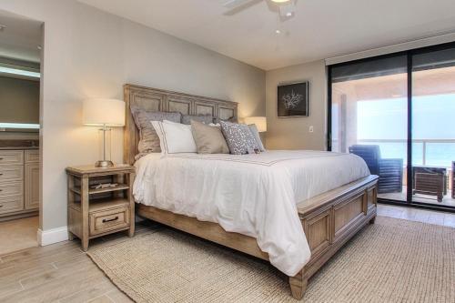 a bedroom with a large bed and a window at Crescent Beach Club II 9A in Clearwater Beach