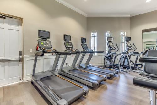 a fitness room with treadmills and cardio machines at Cozy Condo wPrivate Balcony & FREE Resort Access in Orlando