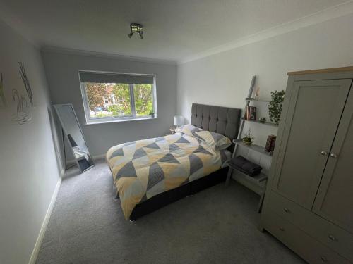 a bedroom with a bed and a window at Canal Side Retreat - 2 Bedroom Apartment in Heybridge