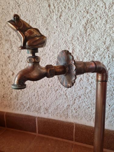 a bronze water faucet with a bird on it at VILLA LA CALA with swimming pool & sea view, 10 min walk from the sea in Blanes