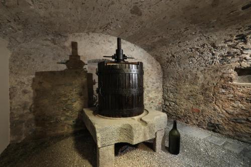 a brick room with a barrel sitting on a table at Charme Hotel al Torchio in Ascona