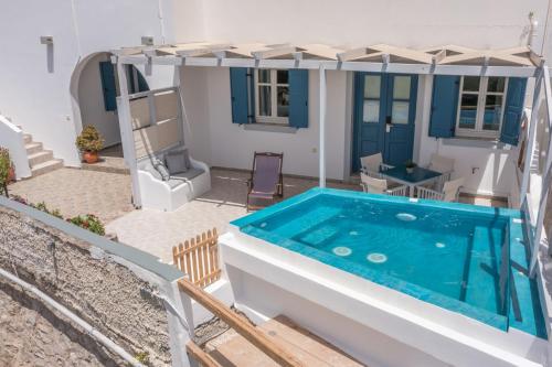 a pool in the backyard of a house at Vira Vivere Houses in Plaka Milou
