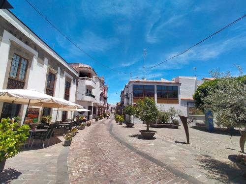 a cobblestone street in a town with buildings at Casa Rural Encarna in Vega de San Mateo