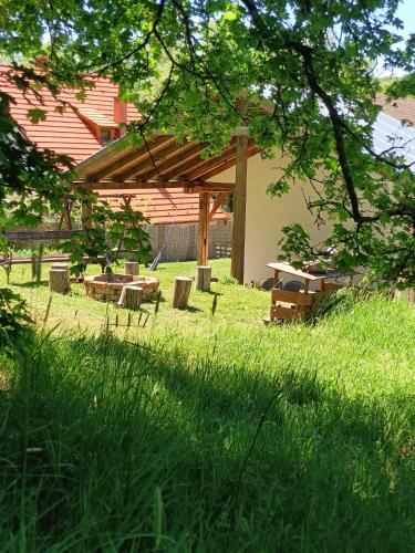 a park with a picnic shelter in the grass at Liget Vendégház in Szokolya