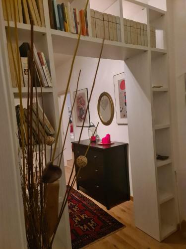 a room with a desk and a shelf with books at Casa Gina & Jeto in Farra di Soligo