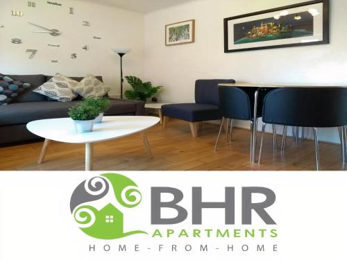 a living room with a couch and a table and chairs at Very Central Location- Parking-4 Beds-2 Bedrooms in Belfast