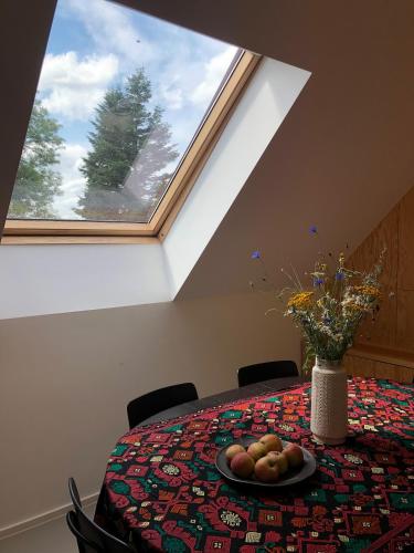 a table with a plate of fruit and a window at Fox in HoÅ¡Å¥ka