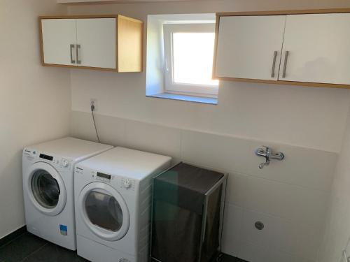 a laundry room with a washing machine and a window at Fox in HoÅ¡Å¥ka