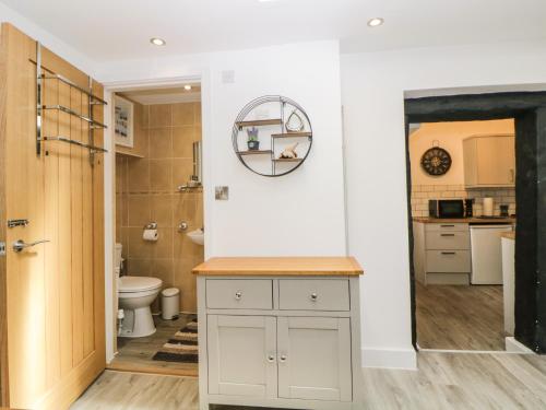 a bathroom with a toilet and a sink with a mirror at Harbour Reach in Torquay