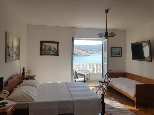 a bedroom with a bed and a view of the ocean at Family Apartment Miluna in Metajna