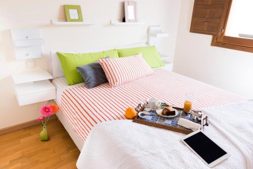 a bedroom with a bed with a tray of food on it at Finca Olivar de Castilla - Sun&Colors in Segovia