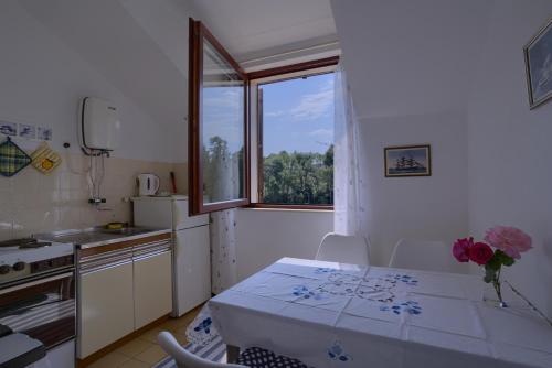 a small kitchen with a table and a window at Apartments Matijasevic in Korčula