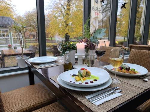 a dining room table with plates of food and a candle at Landhaus Hoisdorf in Hoisdorf