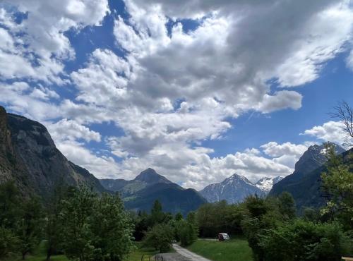 a view of a valley with mountains and clouds at BO LODGE in Le Bourg-dʼOisans