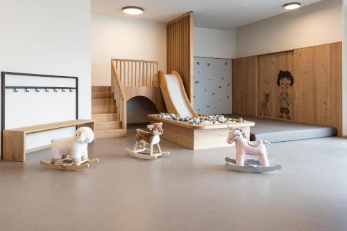 a childs room with toy horses and a crib at Santre dolomythic home in Bressanone
