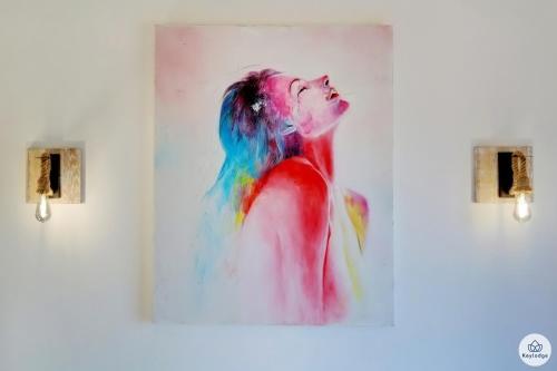 a painting of a woman on a wall at Villa Aïna - Piscine 4 étoiles - Vue mer - Saint Leu in Saint-Leu