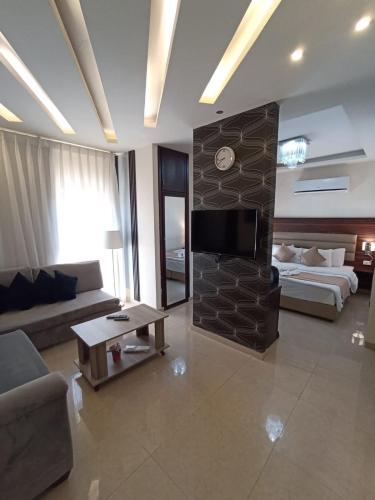 a large living room with a couch and a fireplace at AlQimah Hotel Apartments in Amman