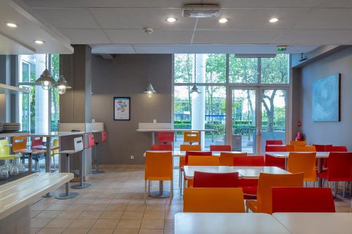 A restaurant or other place to eat at CYAN HOTEL - Roissy Villepinte Parc des Expositions