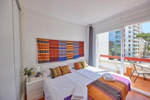 a bedroom with a large bed and a large window at Nura Houses Duplex Magaluf 3 in Magaluf
