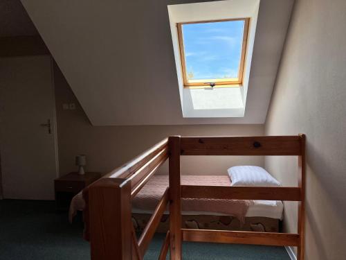 a bedroom with a bunk bed and a window at Hotel Marislav in Češnovice