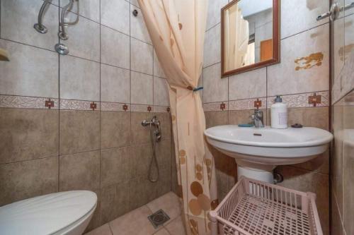 a small bathroom with a toilet and a sink at Apartments Ivana in Bar