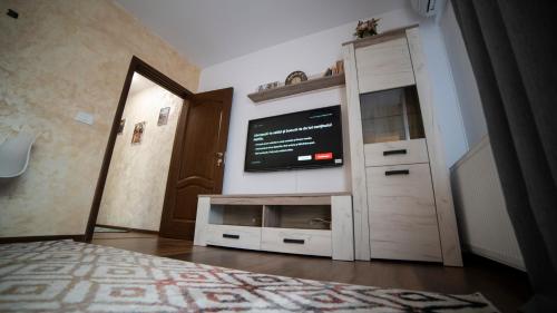 a bedroom with a flat screen tv on a wall at Ballade Apartment in Iaşi